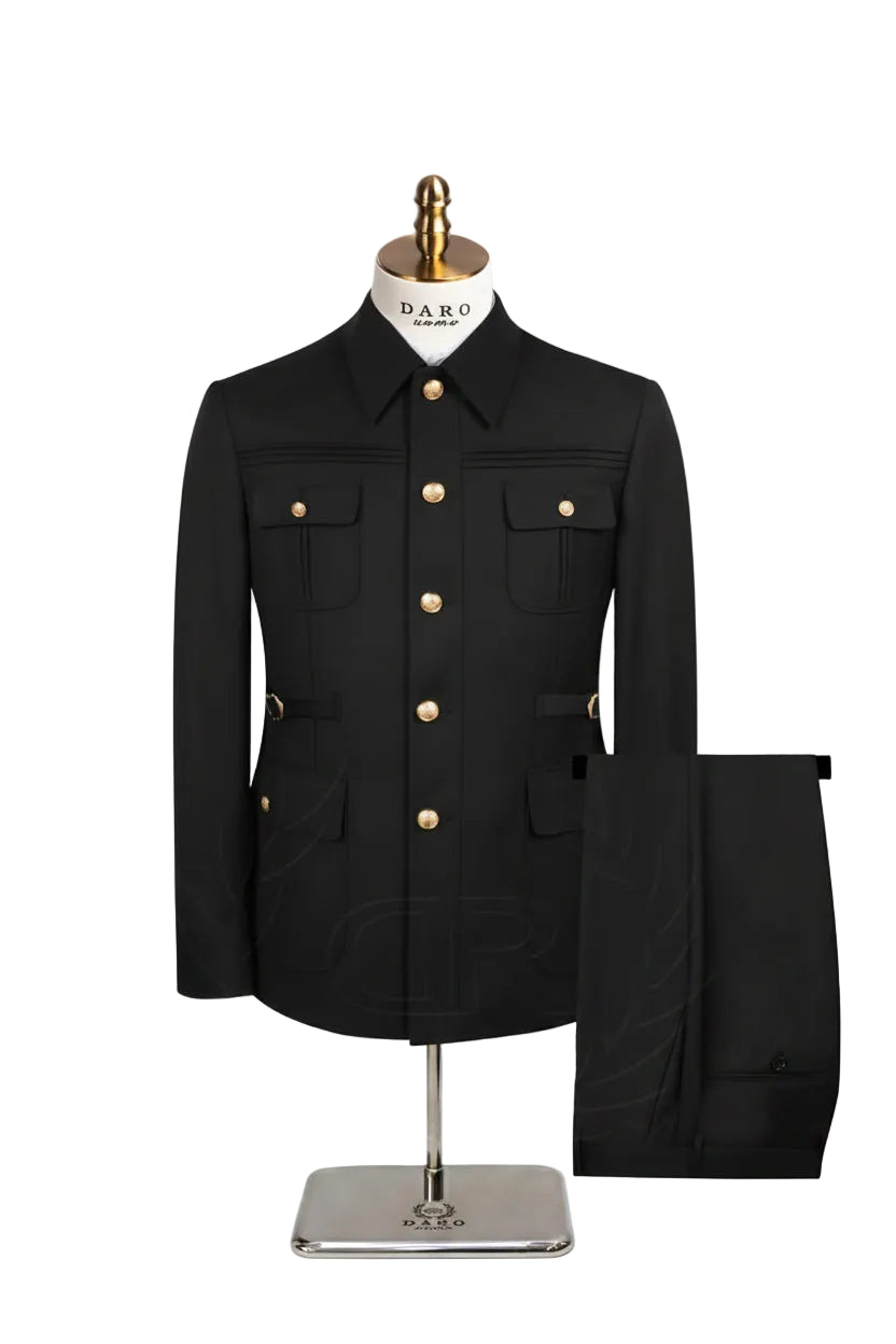 A navy blue men's safari jacket with gold buttons, displayed on a mannequin torso with matching navy trousers beside it. 
