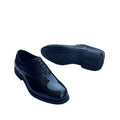 A pair of glossy black Clarks dress shoes displayed on a white surface.