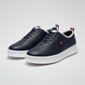 A pair of navy blue Tommy Hilfiger low-top sneakers with white soles, displayed with their branded boxes on a tabletop.